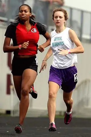 Two female athletes running together